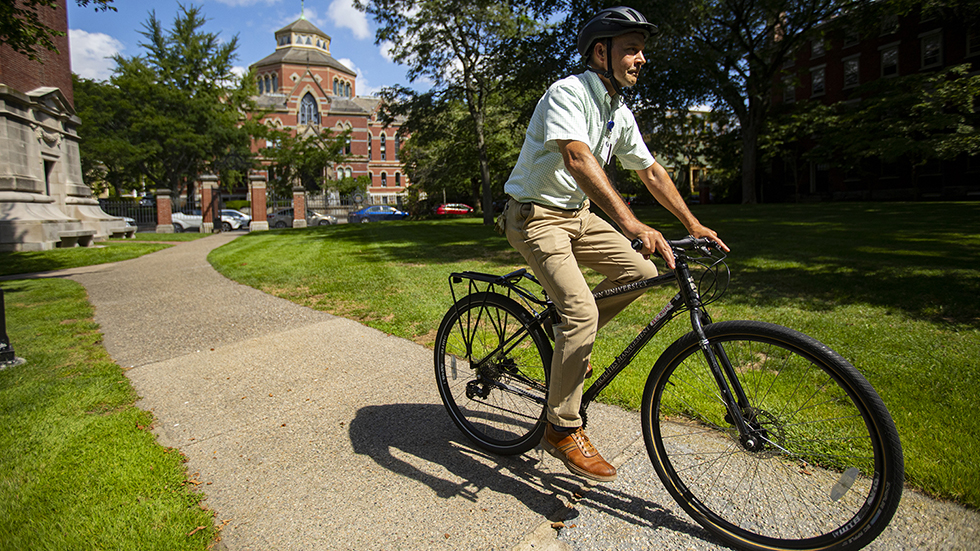 Man riding a bicycle through Brown University