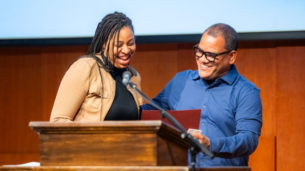 Excellence Award winner on stage receiving award