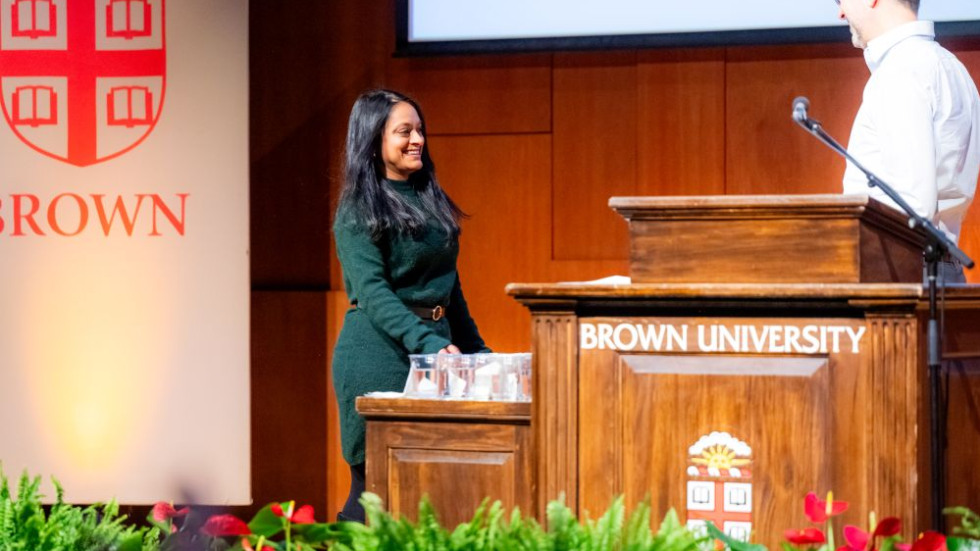 Excellence Award winner on stage receiving award