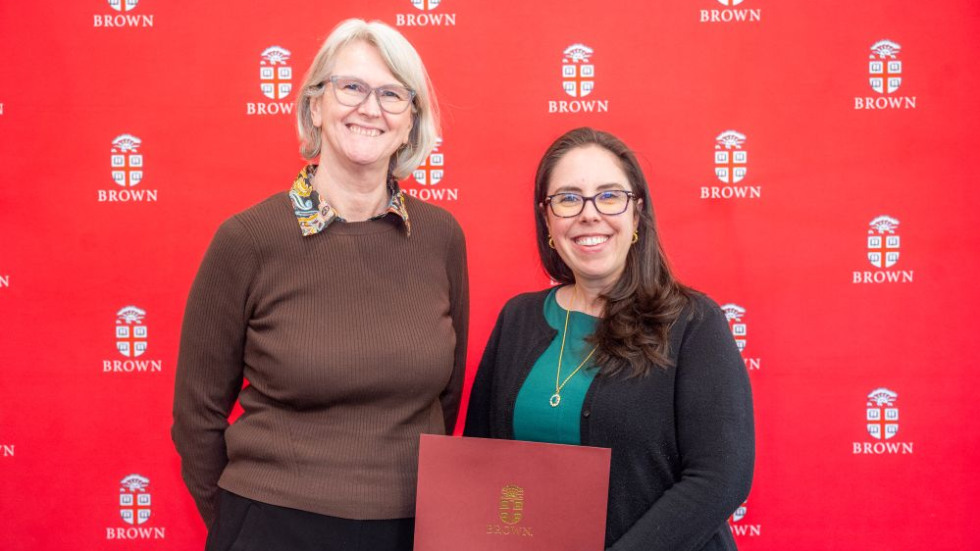 Excellence Award posing with award