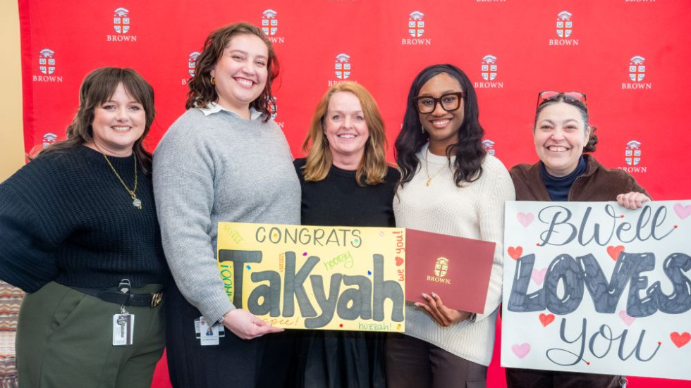 Excellence Award winner group posing with signs